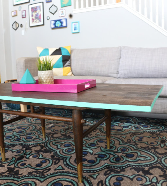 Turn a thrift store coffee table into a modern masterpiece simply by adding a new stained wood top and painting the edge.