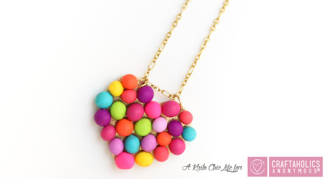 http://www.craftaholicsanonymous.net/diy-mini-pompom-heart-necklace