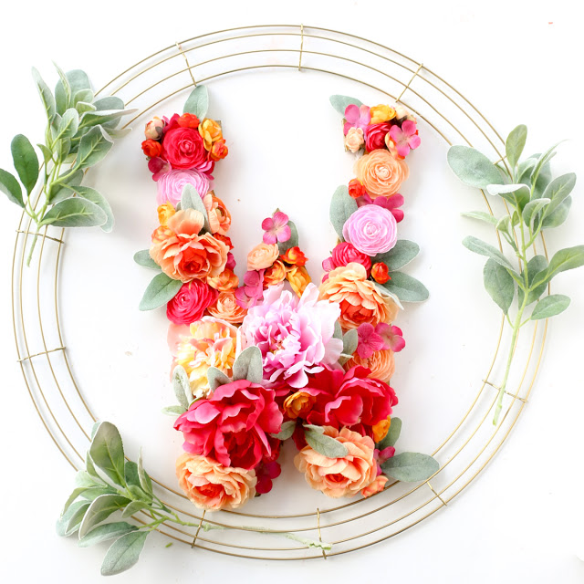Craft a DIY Floral Monogram Wreath for Spring or Summer using gold spray paint and faux flowers from the craft store