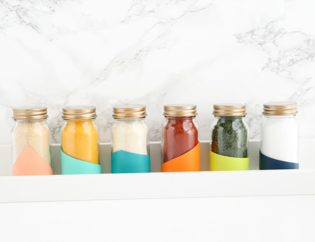 DIY Colorblocked and Gold Topped Spice Jars to help you organize and beautify your pantry or spice rack.
