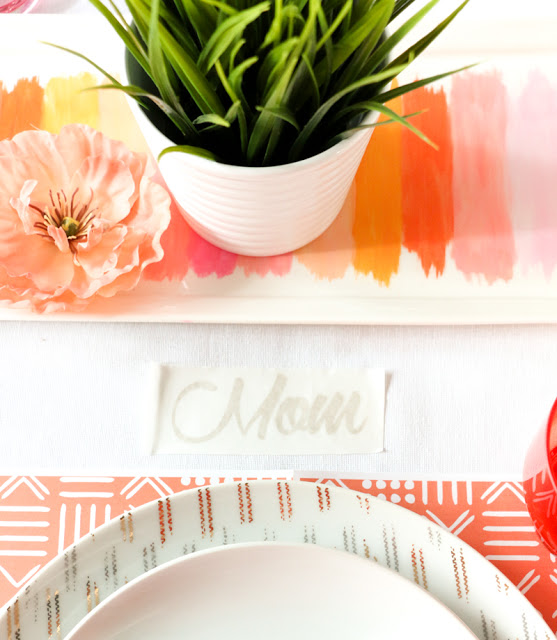 Use adhesive vinyl to deocrate your tablecloth with a temporary design to match your party theme as well as make placecards for each guest