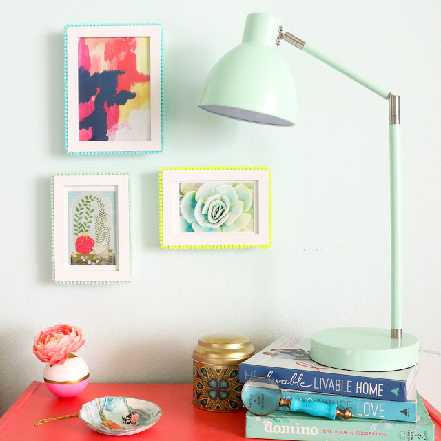 Easy DIY Pom Pom Picture frames. Use pom pom trim and hot glue to craft your own pop of color picture frames for a colorful gallery wall.