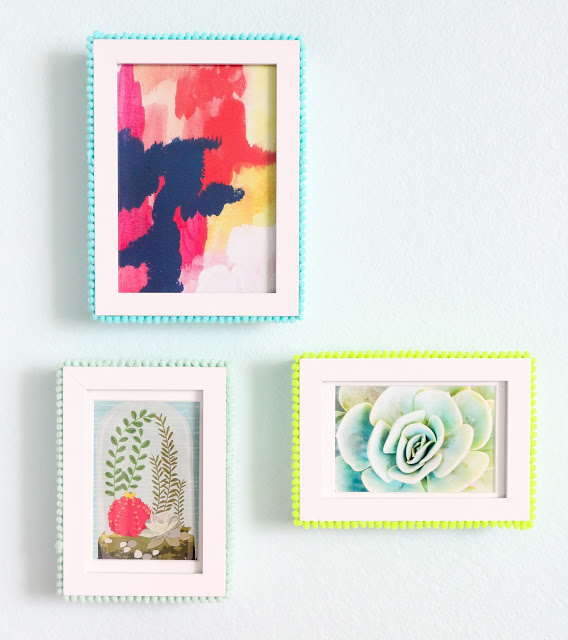 Easy DIY Pom Pom Picture frames. Use pom pom trim and hot glue to craft your own pop of color picture frames for a colorful gallery wall.