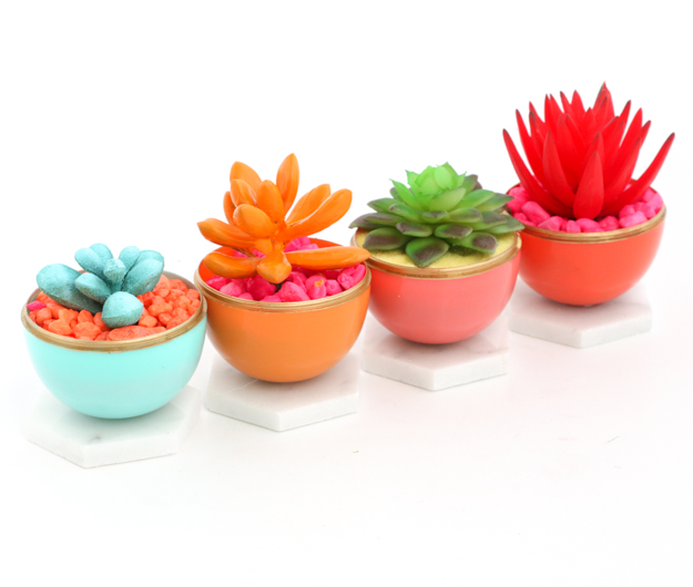 Craft and DIY Mini Neon Succulent Planters using colorful play sand or aquarium rocks and painted succulents in gold edged Easter egg and Marble Planters