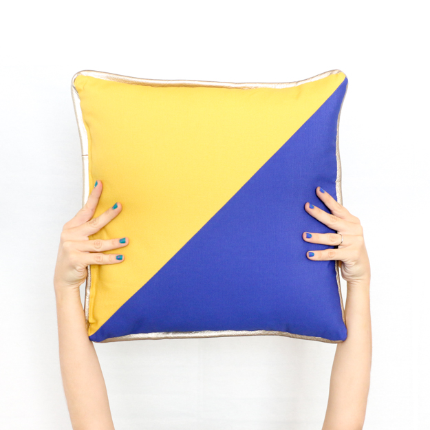 Learn how to sew your own colorblocked triangle pillows with gold piping detail - how to sew - sewing a pillow - fall pillows - jewel tones - sewing - adding piping to pillows - diy - how to - target throw pillows